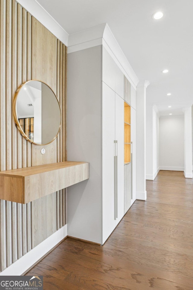 hallway featuring recessed lighting, baseboards, and wood finished floors