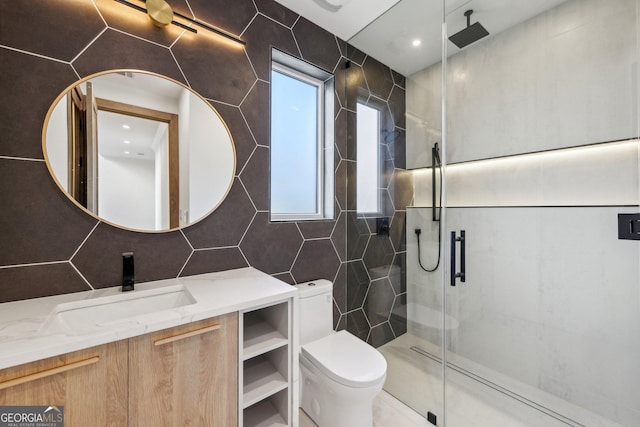 full bath with tasteful backsplash, vanity, toilet, a shower stall, and tile walls