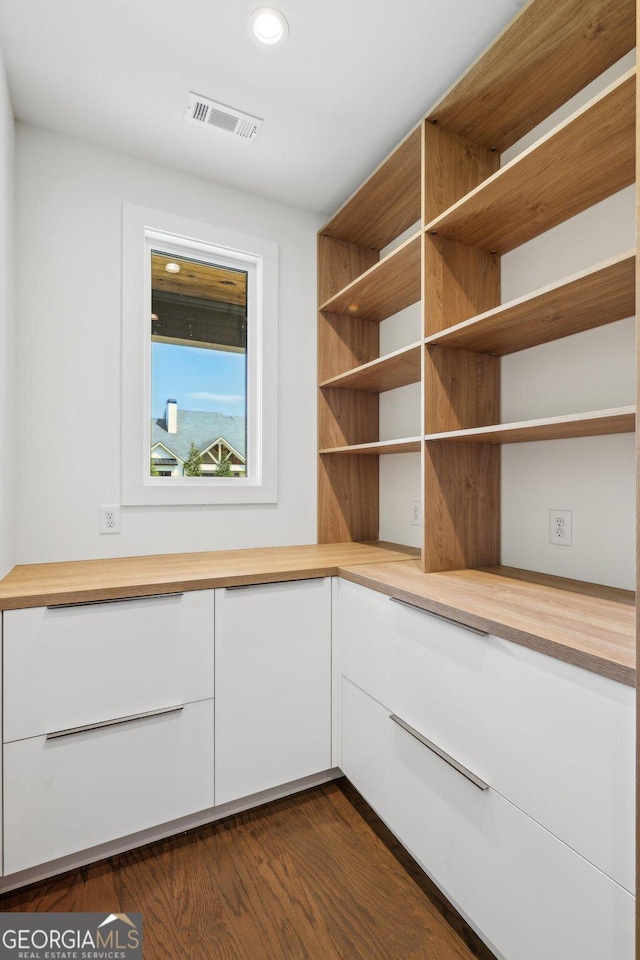 interior space with dark wood-style floors, visible vents, and recessed lighting