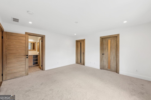unfurnished bedroom featuring carpet flooring, visible vents, and recessed lighting