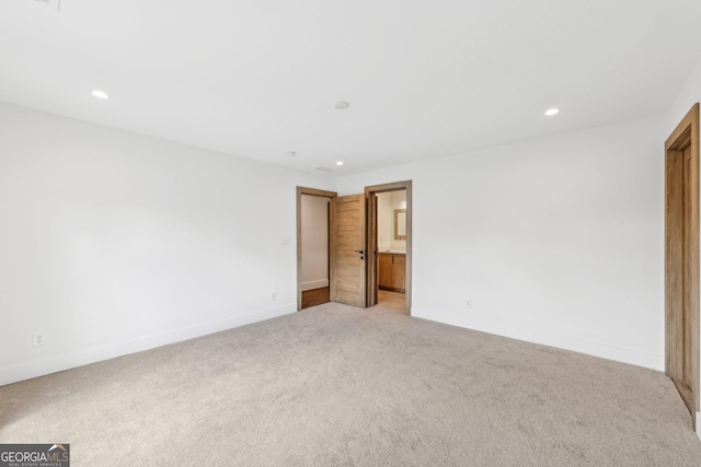 unfurnished room featuring baseboards, recessed lighting, and light colored carpet