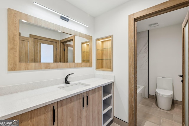 full bathroom with toilet, tile patterned floors, and vanity