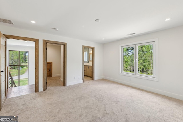 unfurnished bedroom with visible vents, access to exterior, recessed lighting, and light colored carpet