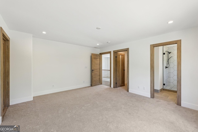 unfurnished bedroom with recessed lighting, light colored carpet, and baseboards