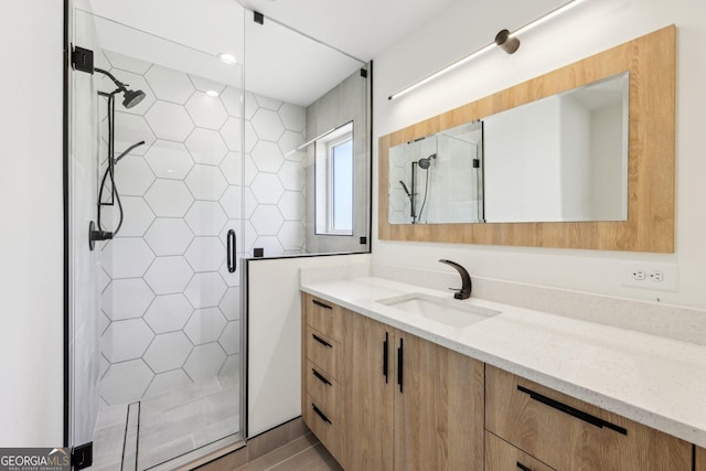 bathroom with vanity and a stall shower