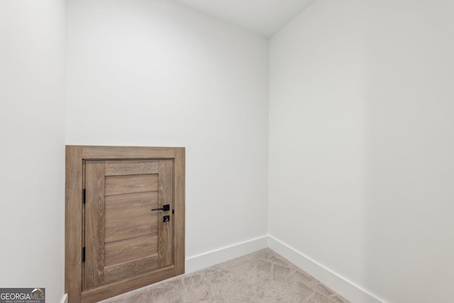 laundry room featuring baseboards and carpet