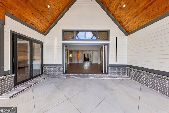 view of exterior entry featuring a patio area and french doors
