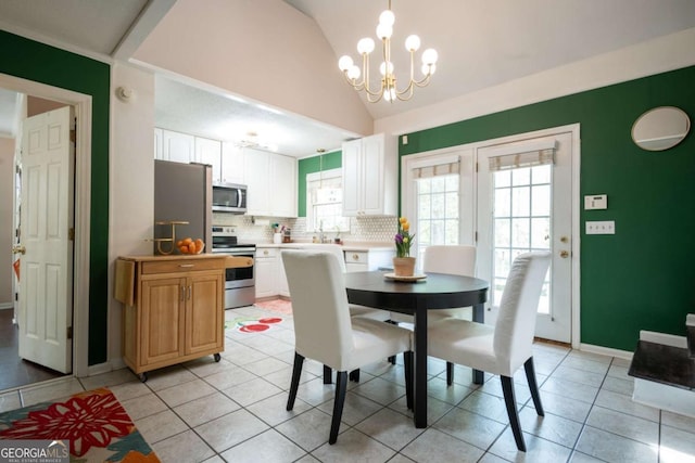 378 Beechwood Dr, Athens, GA 30606 - dining space with light tile patterned floors, baseboards, an inviting chandelier, and vaulted ceiling