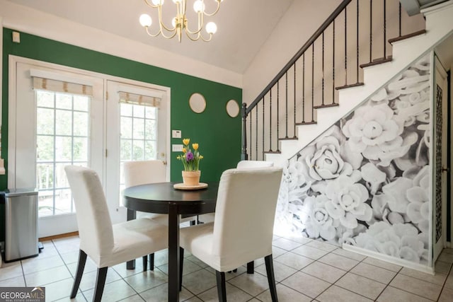 378 Beechwood Dr, Athens, GA 30606 - dining room with light tile patterned floors, a notable chandelier, vaulted ceiling, and stairs