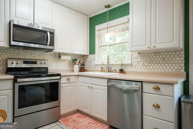378 Beechwood Dr, Athens, GA 30606 - kitchen with a sink, backsplash, white cabinets, and stainless steel appliances