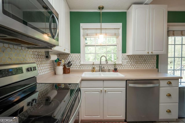 378 Beechwood Dr, Athens, GA 30606 - kitchen with a sink, tasteful backsplash, white cabinetry, and stainless steel appliances