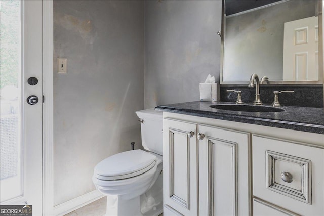 bathroom featuring toilet and vanity
