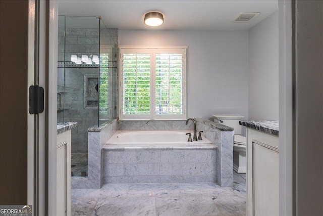 bathroom with a bath, toilet, vanity, and a stall shower