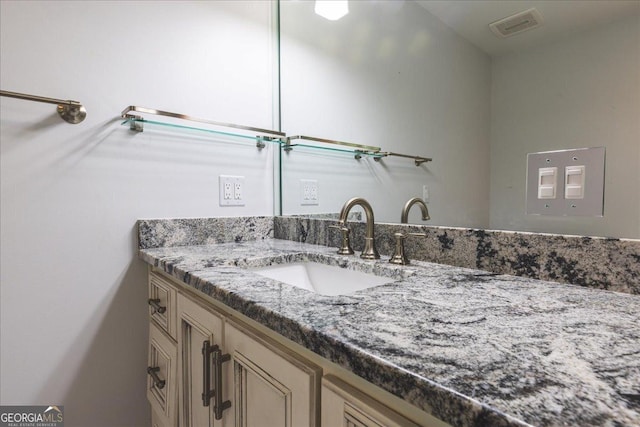 bathroom with vanity and visible vents
