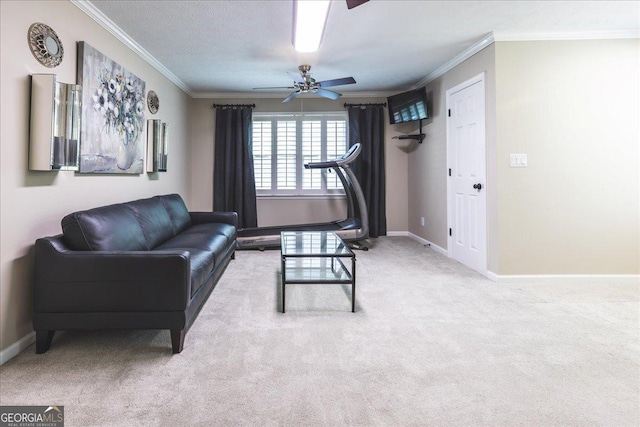carpeted living room with a ceiling fan, baseboards, and ornamental molding