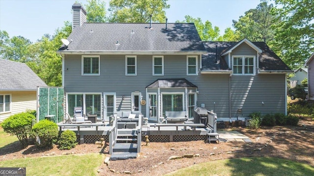 back of property featuring a chimney, outdoor lounge area, and a deck