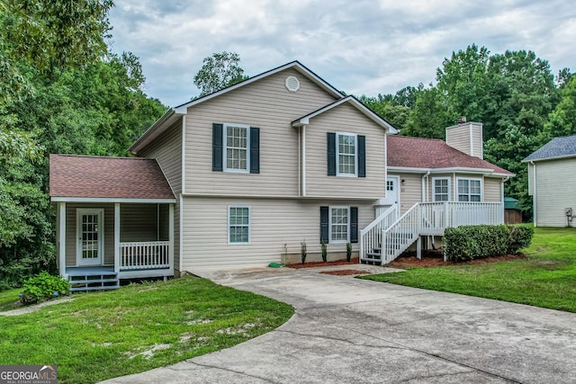 61 Meadowbrook Ln, Carrollton, GA 30117 - tri-level home featuring covered porch, a front yard, driveway, and roof with shingles