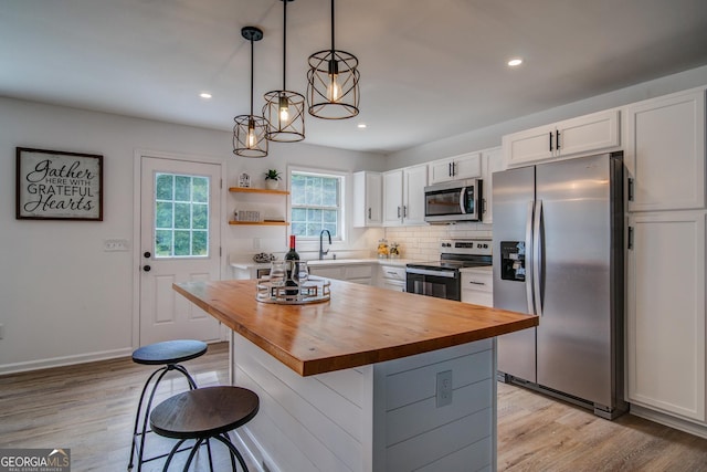 61 Meadowbrook Ln, Carrollton, GA 30117 - kitchen with stainless steel appliances, wood counters, white cabinets, light wood-style flooring, and recessed lighting