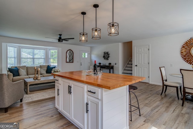 61 Meadowbrook Ln, Carrollton, GA 30117 - kitchen featuring wood counters, white cabinetry, light wood-type flooring, and a kitchen breakfast bar