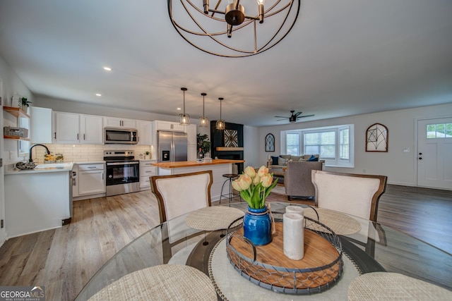 61 Meadowbrook Ln, Carrollton, GA 30117 - dining area with light wood-style flooring, ceiling fan, recessed lighting, and a chandelier