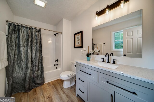 61 Meadowbrook Ln, Carrollton, GA 30117 - bathroom with wood finished floors, vanity, shower / bathtub combination with curtain, and a textured ceiling