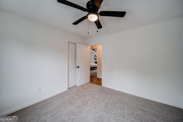 61 Meadowbrook Ln, Carrollton, GA 30117 - unfurnished bedroom with carpet flooring, a closet, and ceiling fan