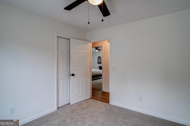 61 Meadowbrook Ln, Carrollton, GA 30117 - unfurnished bedroom with carpet floors, a closet, and a ceiling fan