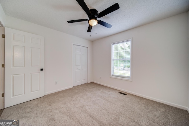 61 Meadowbrook Ln, Carrollton, GA 30117 - unfurnished bedroom featuring carpet, a closet, and ceiling fan