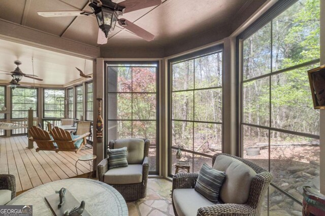 sunroom / solarium featuring ceiling fan