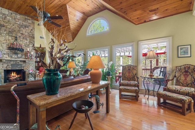 living room featuring a fireplace, hardwood / wood-style floors, wooden ceiling, and ceiling fan