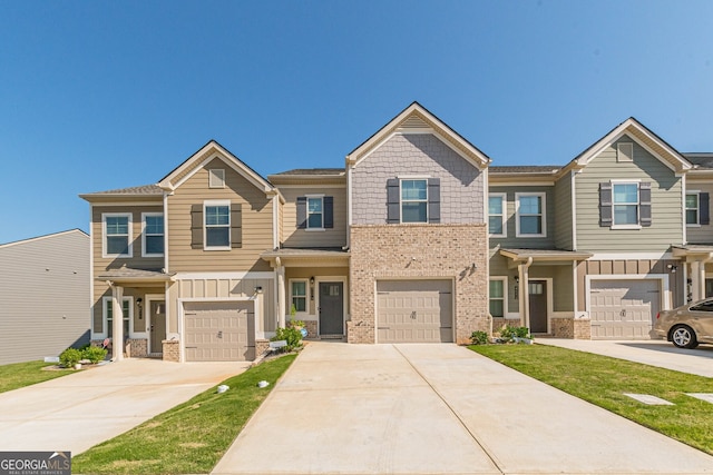 multi unit property with an attached garage, driveway, and brick siding