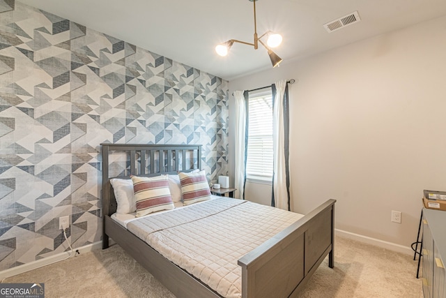bedroom with light carpet, visible vents, and baseboards