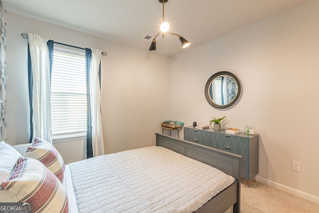 bedroom with visible vents, light colored carpet, baseboards, and a ceiling fan