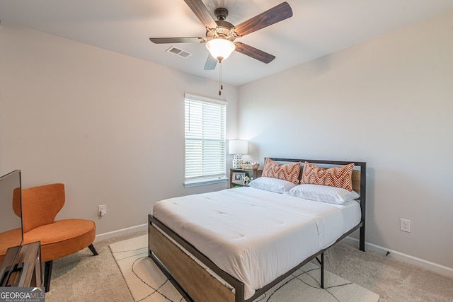 bedroom featuring visible vents, light colored carpet, and baseboards