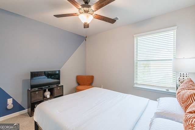 bedroom with light carpet, ceiling fan, baseboards, and visible vents