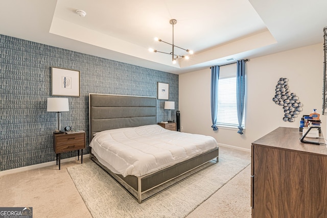 carpeted bedroom featuring a raised ceiling, a chandelier, baseboards, and visible vents