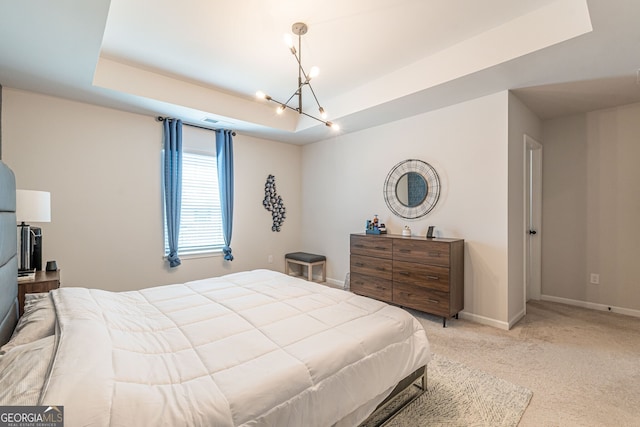 bedroom featuring a chandelier, light carpet, baseboards, and a raised ceiling