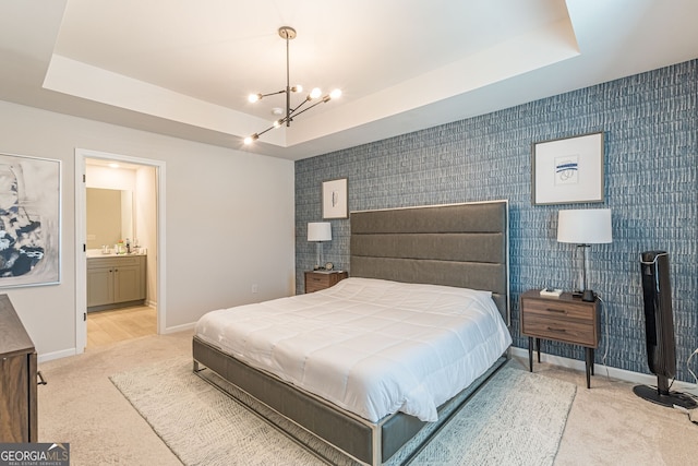 bedroom with carpet flooring, baseboards, an inviting chandelier, and connected bathroom