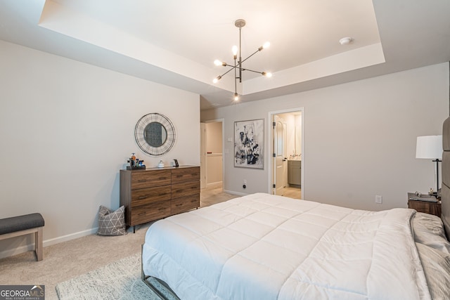 bedroom with light colored carpet, a notable chandelier, a tray ceiling, and baseboards