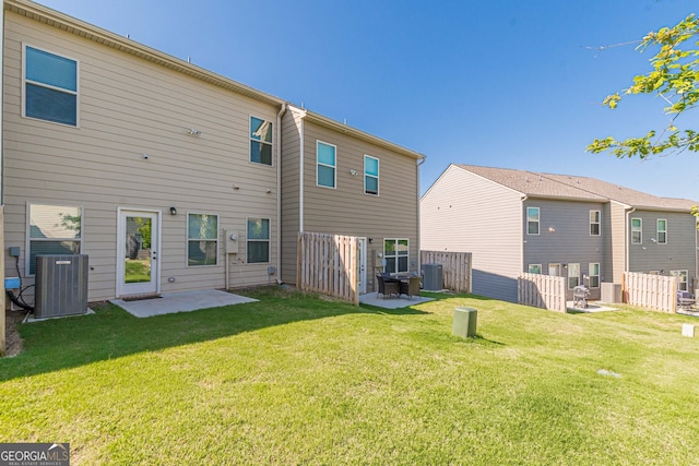 rear view of property with central AC, a patio, and a lawn