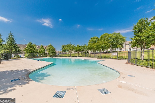 pool with fence and a patio