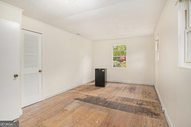 empty room with baseboards and hardwood / wood-style floors