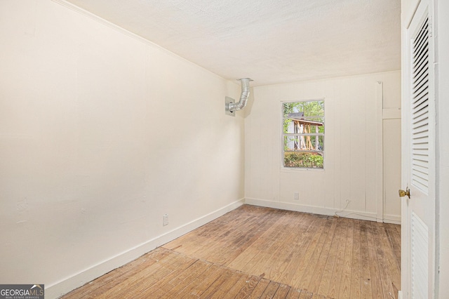 unfurnished bedroom featuring light wood-type flooring and baseboards