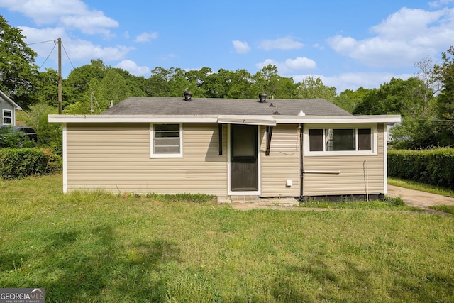 rear view of house with a lawn