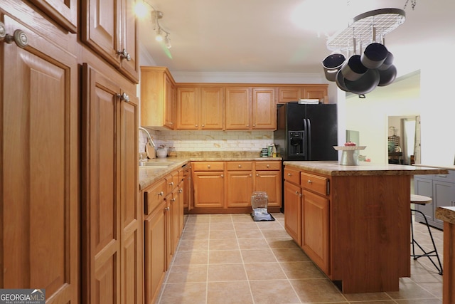 4650 Perry Rd, Gainesville, GA 30506 - kitchen featuring a kitchen breakfast bar, light tile patterned floors, a sink, backsplash, and black fridge
