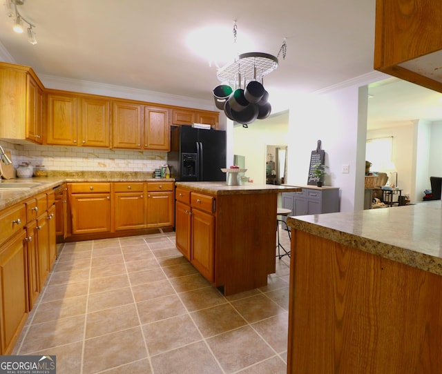 4650 Perry Rd, Gainesville, GA 30506 - kitchen with black refrigerator with ice dispenser, a kitchen island, light tile patterned flooring, and tasteful backsplash