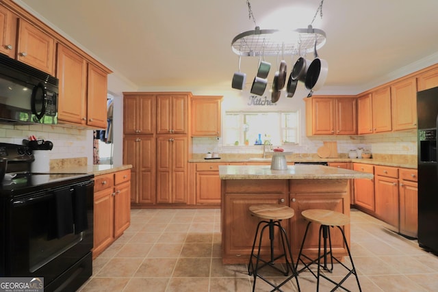 4650 Perry Rd, Gainesville, GA 30506 - kitchen with decorative backsplash, ornamental molding, black appliances, and a kitchen bar