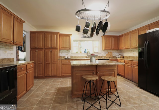 4650 Perry Rd, Gainesville, GA 30506 - kitchen with a kitchen bar, light tile patterned floors, black appliances, and tasteful backsplash
