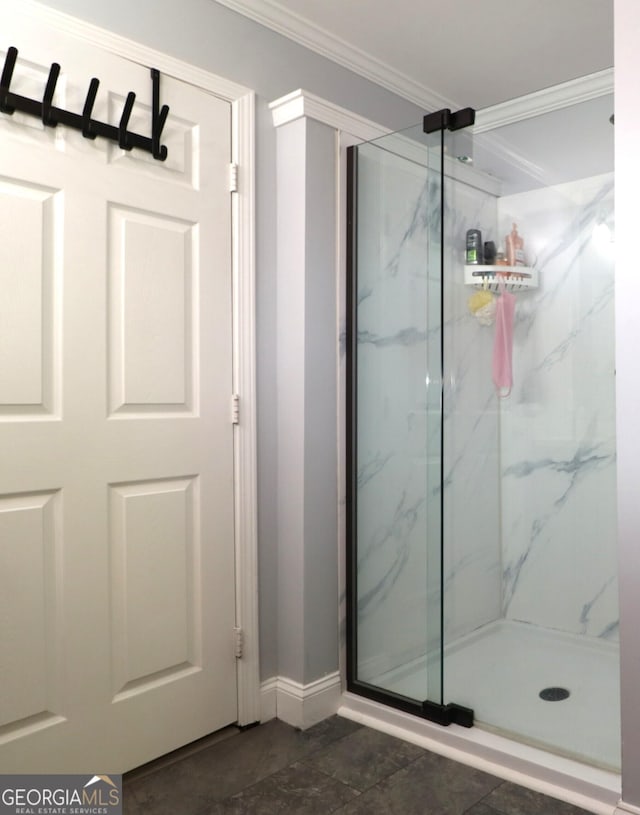4650 Perry Rd, Gainesville, GA 30506 - bathroom featuring baseboards, ornamental molding, and a marble finish shower