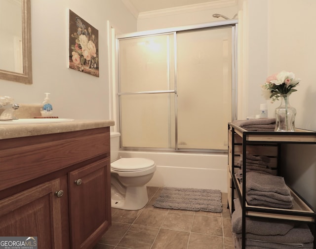 4650 Perry Rd, Gainesville, GA 30506 - bathroom featuring vanity, ornamental molding, tile patterned flooring, toilet, and bath / shower combo with glass door